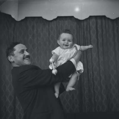Portrait of a father holding the baby
