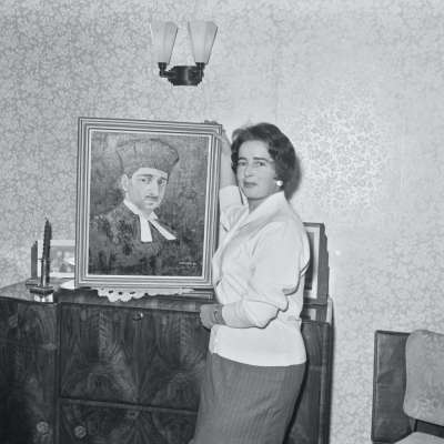 Portrait of a woman with painting of religious figure