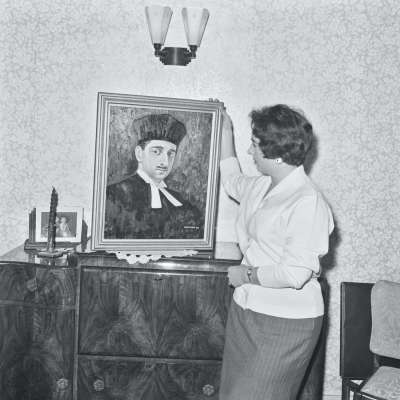 Portrait of a woman with painting of religious figure