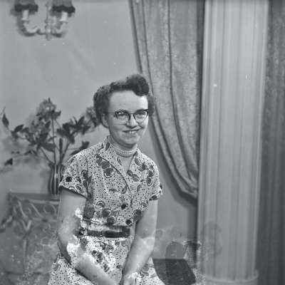 Portrait of woman in patterned dress and glasses