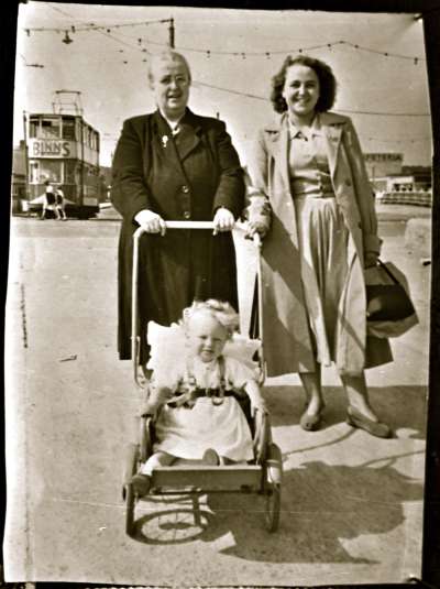 Two women and a baby in a pram