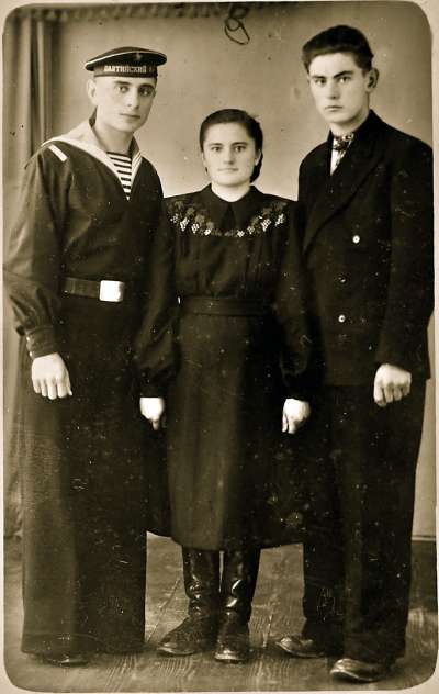 Portrait of sailor with family group