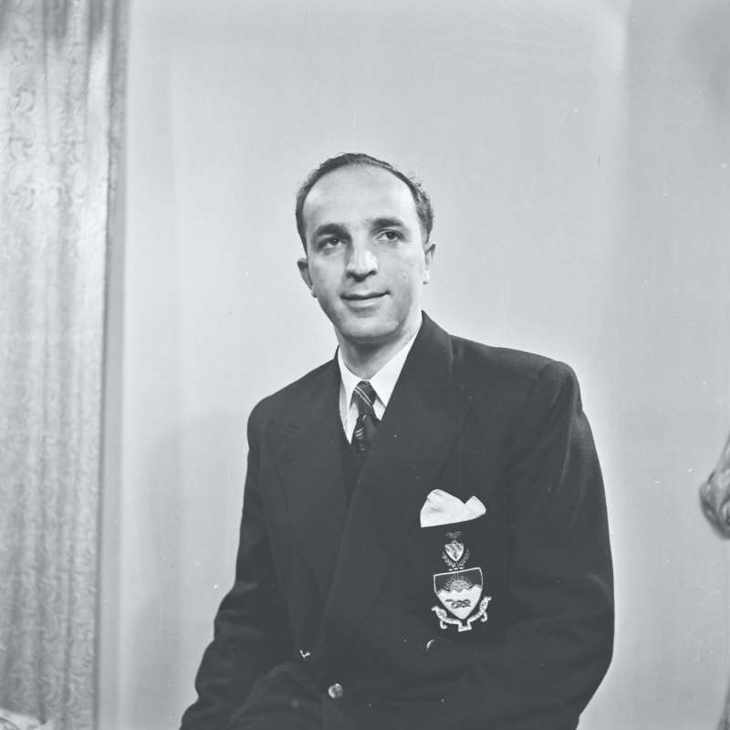Portrait of a man wearing blazer with insignia