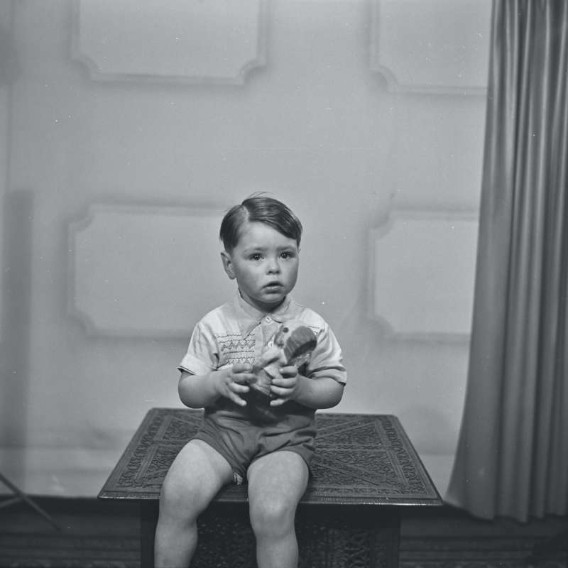 Portrait of a boy holding doll