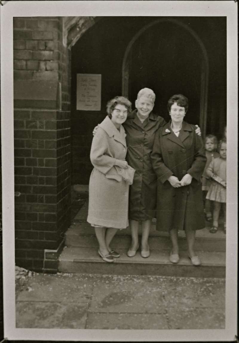 Portrait of three women outside Church