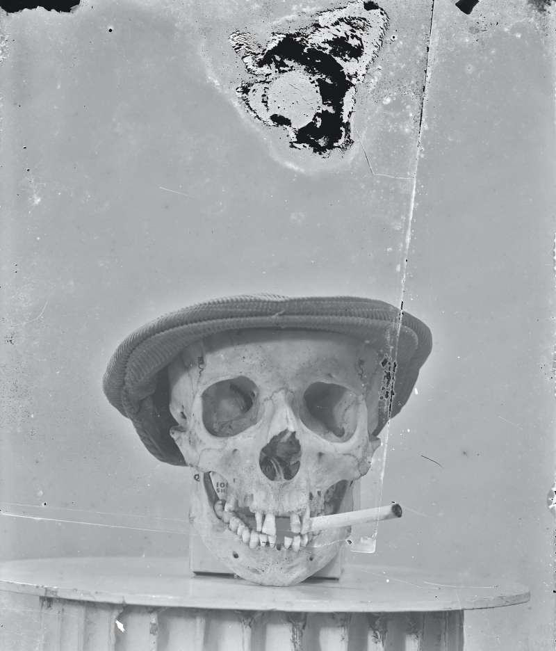 Advert of skull with hat and cigar