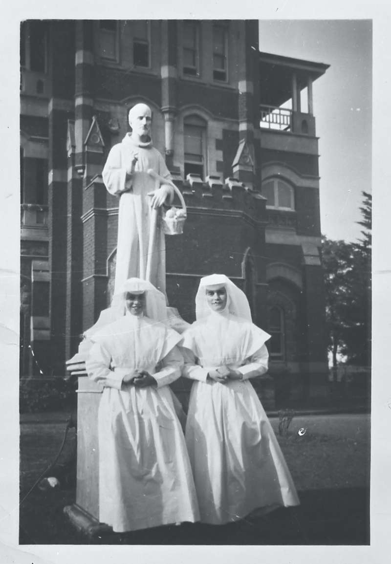 Nuns in front of statue