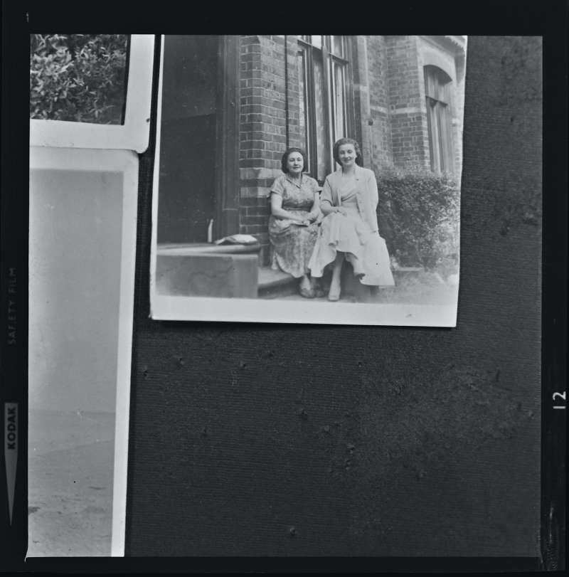 Portrait of two women outside a house